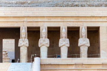 Wall Mural - The Hatshepsut statues by the columns on the highest terrace of the Mortuary Temple of Hatshepsut, Luxor, Egypt