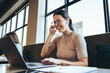 © Jacob Lund - Happy businesswoman taking a video call in a co-working space