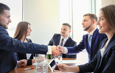 Poster - Business people shaking hands, finishing up a meeting