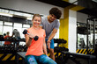 © NDABCREATIVITY - Portrait of happy fit people, friends exercising in gym together. Sport people workout concept