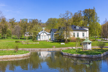 Wall Mural - Park pond with old wooden houses in the spring