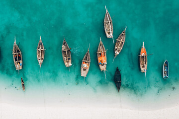 top view or aerial view of beautiful crystal clear water and white beach with long tail boats in sum