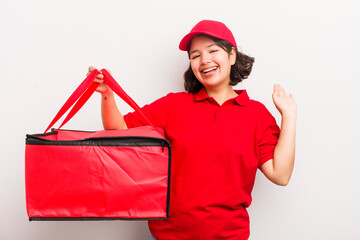 Wall Mural - pretty hispanic girl smiling happily, waving hand, welcoming and greeting you. fast food delivery concept