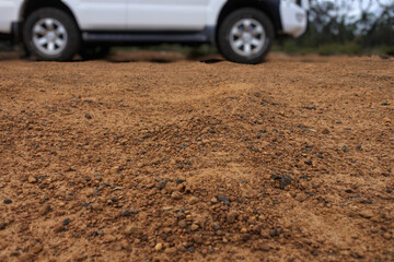 4WD vehicle driving on a very corrugate dirt road in Australia outback