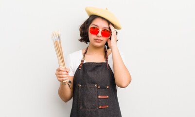 Wall Mural - pretty hispanic girl feeling bored, frustrated and sleepy after a tiresome. art student concept