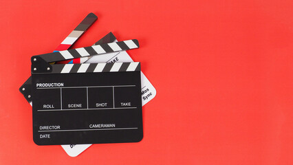 Two Black and white clapper board or movie slate on red background. full shot