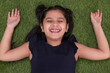 © IndiaPix - Overhead view of girl child lying on grass