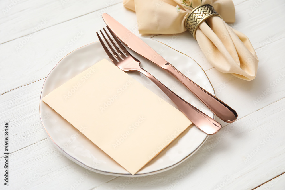 Simple table setting on light wooden background, closeup