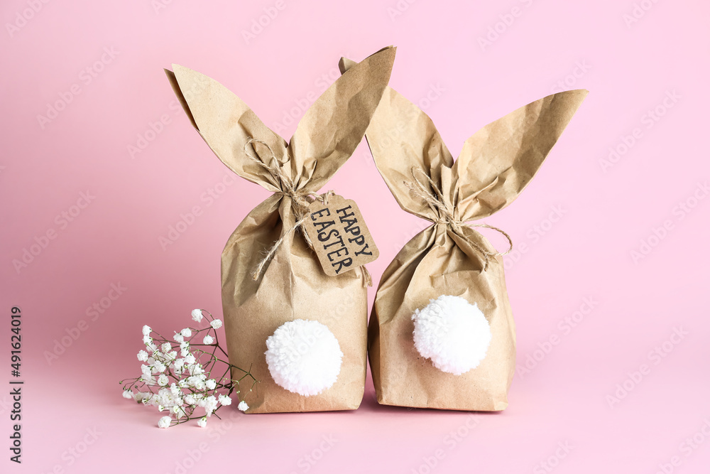 Paper bags bunny on color background