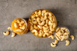 Sweet cashew nuts in honey on grunge background