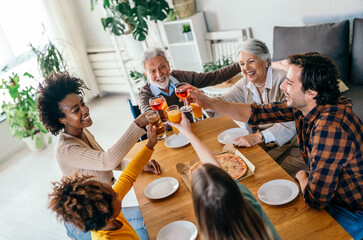 Wall Mural - Multiethnic, three generation family together celebration with parents grandparents and children