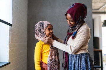 Arabian muslim family, mother and child spending time together at home.