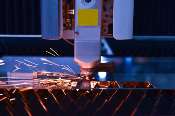 Wall Mural - industrial laser cut machine while cutting the sheet metal with the sparking light.