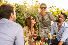 Young Group Of 30s People Having Fun At A Cocktail Party Outdoor, Beautiful Women Smiling And Laughing With Friends, Handsome Men Talking With Elegant Female Millenials