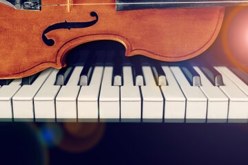 Wall Mural - Violin on top of piano keyboard background for music concept