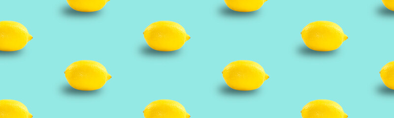 Juicy ripe flying yellow lemons on blue background. creative food concept. Tropical organic fruit, citrus, vitamin C. Lemon slices. Summer minimalistic bright fruit background. pattern. banner. 