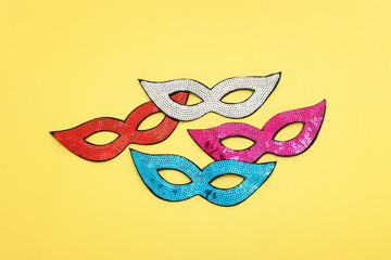 Wall Mural - Holidays image of carnival party sequins masks over yellow background. view from above