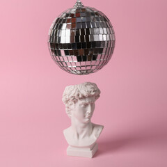 Wall Mural - Bust of David with a disco ball on a pink background. Minimal party concept. Creative contemporary still life