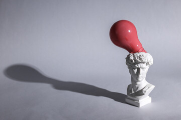 Wall Mural - Antique David bust with pink light bulb on gray background. Conceptual pop. Minimal still life. Creative idea