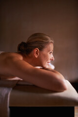 Wall Mural - Relaxing at the day spa. Cropped shot of a woman in a day spa relaxing on a massage table.