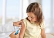 © BillionPhotos.com - Female nurse giving an arm injection to a child. Little kid in getting a shot at a modern vaccination center. Covid 19 vaccine to a little girl