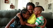 © Marco - African mother embracing teen daughter and little boy son. African black ethnicity, love and affection