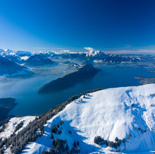 Aerial View Of Vierwaldstattersee Lake In Wintertime With Snow, A Lake Between Switzerland And Italy Border.