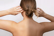 © Марина Демешко - A young caucasian woman standing with her back before and after tanning isolated on a white background. The result of self-tanning. Tanned skin, contrast of skin colors