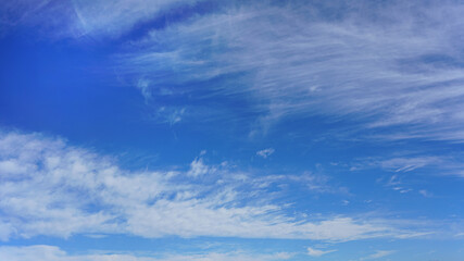 Wall Mural - white clouds and blue sky suitable for background or sky replacement.