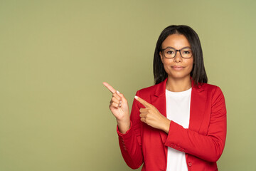 Confident african american businesswoman in red jacket point fingers to copy space demonstrating object, new product for advertisement. Successful black woman customer show hand advertising service