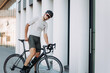 © Tymoshchuk - Professional cyclist posing with black bike at urban area