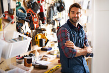 Lets Fix It. Portrait Of A Handsome Young Handyman Standing In Front Of His Work Tools.