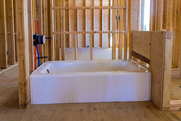 Canvas Print - A under construction new building with Installed new acrylic bathtub