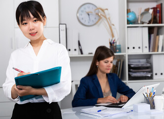 Wall Mural - Portrait of successful confident chinese business woman in office interior