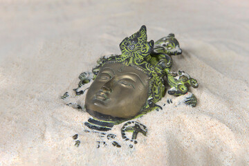 Wall Mural - Ancient Buddha face on the sand