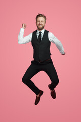 Happy businessman jumping and smiling