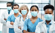 © Chanelle Malambo/peopleimages.com - Working on the frontline with patients during the pandemic. Portrait of a group of medical practitioners wearing face masks while standing together in a hospital.
