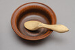 Brown earthenware bowl and buckshot against a gray background.