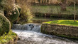 Weir on the River Frome in the old Brimscombe Port area of Stroud, The Cotswolds, Gloucestershire, United Kingdom