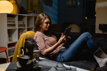 Wall Mural - woman using digital tablet at home. night scene