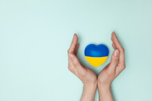 Heart With Print The National Flag Of Ukraine In Female Hand. Flat Lay. Copy Space.