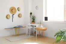 Interior Of Modern Stylish Room With Surfboard, Table And Female Accessories
