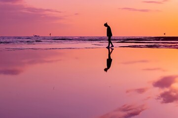 silhouette of a person on the beach at sunset