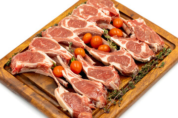 Poster - lamb chops isolated on a white background. raw lamb chops on wood serving board