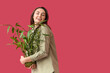 © Pixel-Shot - Beautiful young woman with houseplant  on color background
