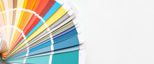 Color Guide Close Up. Assortment Of Colors For Design. Colors Palette Fan On White Concrete Wall Background. Graphic Designer Chooses Colors From The Color Palette Guide. Coloured Swatches Catalogue