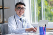 © Timeimage - Image of young Asian doctor working at clinic
