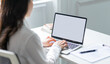 © Timeimage - Image of young Asian business woman using laptop with blank screen