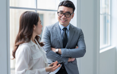 Wall Mural - Two Asian businesspeople working at office