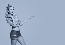 Young Happy Smiling Woman, Dressed In Pin Up Style, Showing Something Or Copyspace Area For Text Or Slogan. Blond Girl Posing In Retro Fashion And Vintage Concept. Black And White.
